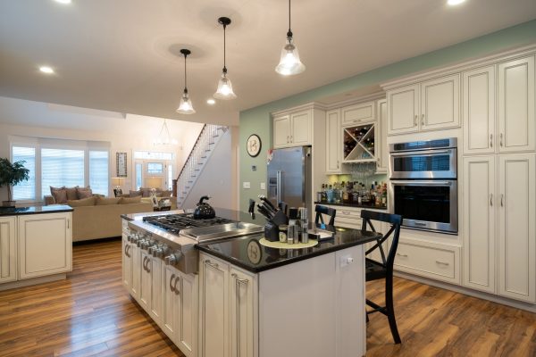 A luxury kitchen interior with white island and built-in cabinetry
